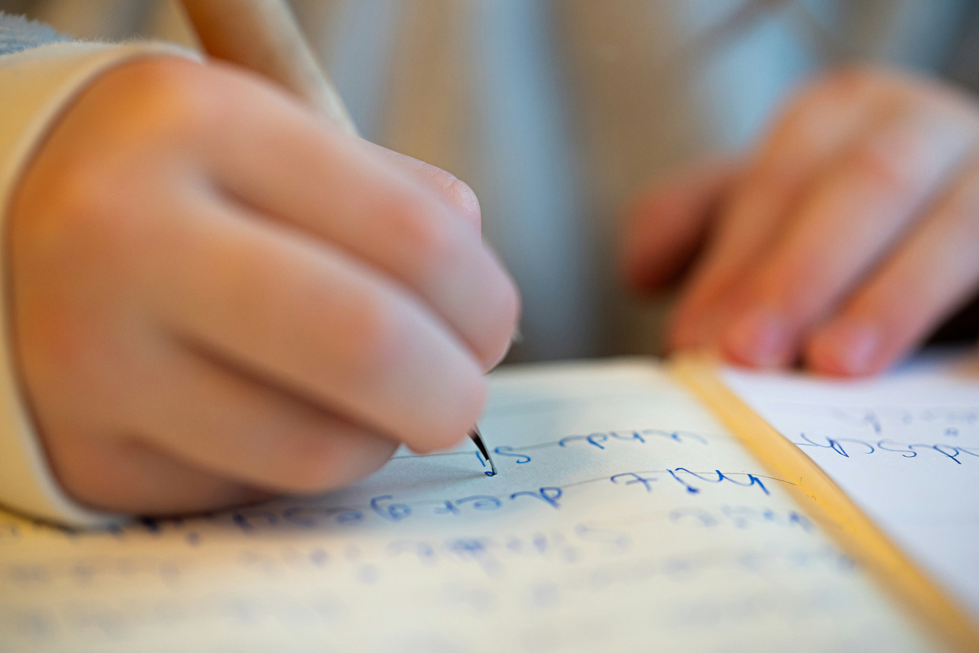 Child practicing handwriting with pediatric occupational therapist